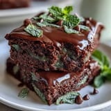 Festive St. Patricks Day mint chocolate chip brownie bites topped with mini chocolate chips and a hint of green.