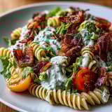 Colorful BLT pasta with juicy tomatoes, chopped romaine, and rich avocado ranch dressing—perfect for picnics.  