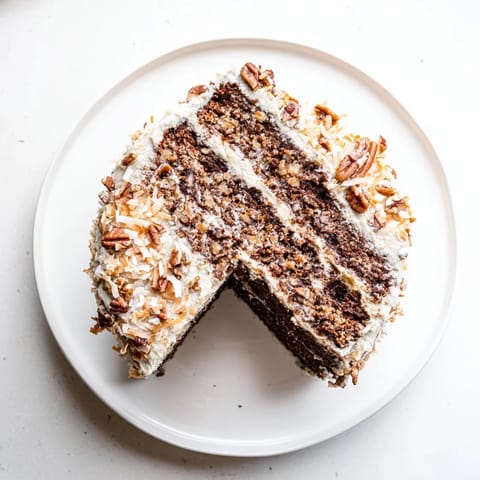 Golden-brown German Chocolate Cake with sticky coconut-pecan topping, perfect for celebrations and parties.