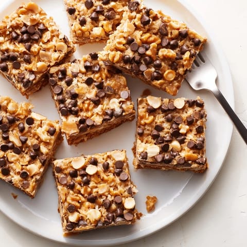 Decadent Hello Dolly Bars cut into squares showing layers of chocolate and coconut.
