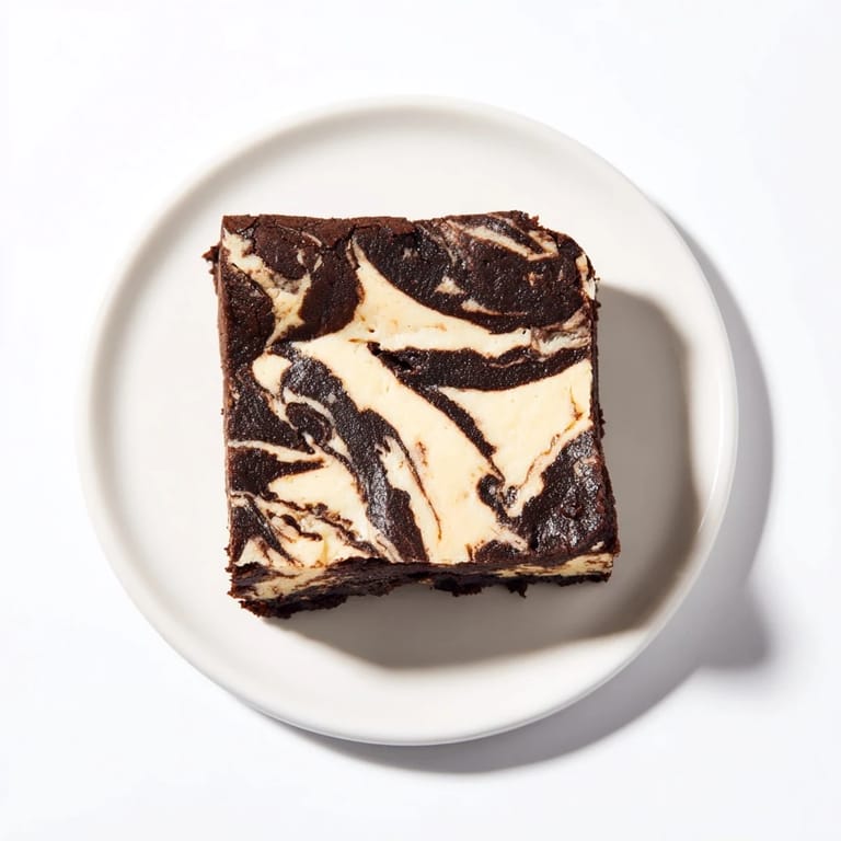 Four stacked Cheesecake Brownies on a white plate, perfect for serving as a decadent dessert at a party or bake sale.