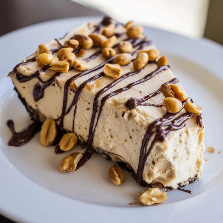 Fluffy, no-bake Peanut Butter Pie filling in a chocolate crust, garnished with chocolate shavings and ready to serve.