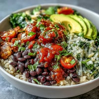 Colorful plant-based taco bowl bursting with fresh salsa and seasoned black beans.